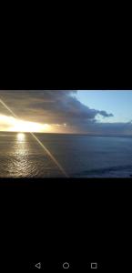 a picture of a sunset over the ocean at Isabela House in Ponta do Sol