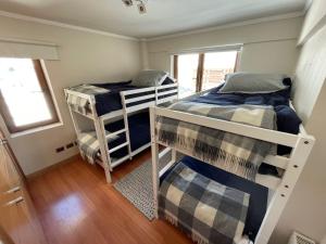 a room with two bunk beds and a window at Departamento Valle Nevado, Ski in - Ski out in Santiago