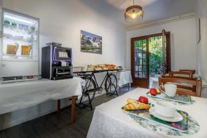 a living room with two tables and a microwave at Hôtel Saint Clair in Lourdes