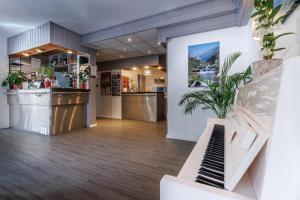 a lobby of a store with a counter and a plant at Hôtel Saint Clair in Lourdes