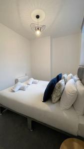 a bed with pillows on it in a room at Suite 1- Luxury 1 Bed Apt- Leicester City- Free Parking in Leicester