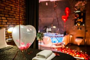 a glass heart balloon sitting on top of a table at Leo Apartments Old Town in Krakow