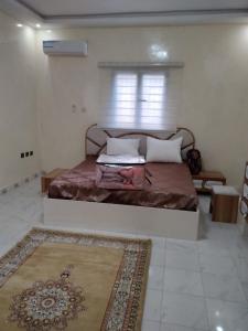 a bedroom with a large bed with a window at النسيم Nessim in Nouakchott