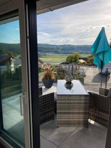 vistas a un patio con mesa y sombrilla en Ferienwohnung Ederseeblick en Waldeck