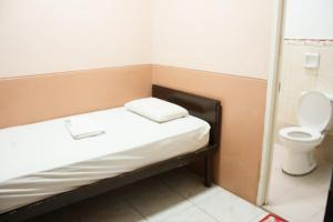 a small room with a bed and a toilet at GV Hotel - Tacloban in Tacloban +26 photos