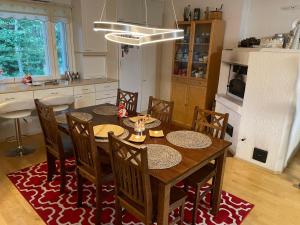 a kitchen with a dining room table and chairs at Blue Dream House in Rovaniemi