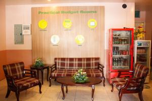 a room with chairs and a table and a refrigerator at GV Hotel - Tacloban in Tacloban