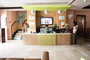 a lobby of a restaurant with people standing at a counter at GV Hotel - Tacloban in Tacloban