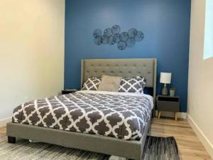 a bedroom with a bed with a blue wall at 4BR Townhouse in Mid City in Los Angeles
