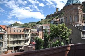a view of a city with buildings and a mountain at Millennium Tbilisi in Tbilisi City