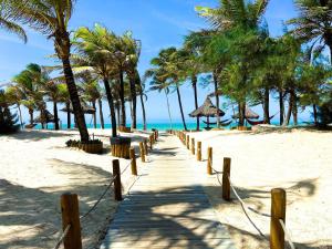a pathway on a beach with palm trees and the ocean at Resort VG SUN por Be My Guest! in Caucaia