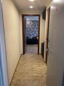 a hallway leading to a living room with a couch at Luxury Apartment in Tbilisi City Centre in Tbilisi City