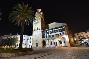 a large building with a clock tower at night at Apartamento Daniela 1 in Ronda
