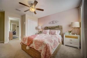 a bedroom with a bed and a ceiling fan at 6BR Resort Private Pool BBQ in Davenport