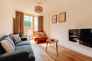 a living room with a couch and a tv at Redland Stay In Bespoke Home 2 of 2 in Bristol