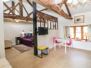 a living room with a table and a bed at The Forge in Taunton