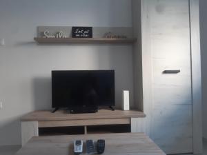 a flat screen tv sitting on top of a wooden table at Stojanović Apartments in Niš