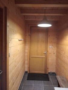 a hallway with a wooden door in a room at Maison écoresponsable classée 3 étoiles avec son jardin clos in Donzy