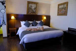 a bedroom with a large bed with two towels on it at Washington Hotel in Casablanca