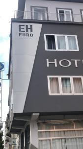 a building with a hotel sign on the side of it at Eurohotel in Piacenza