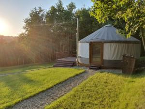 a yurt in a yard with a grass field at Jurty na Polanie Karol&Franek in Owczary