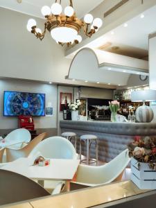a restaurant with white chairs and a bar at Eurohotel in Piacenza