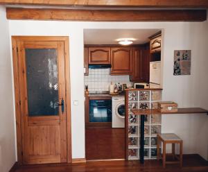 a kitchen with a door leading into a kitchen with a counter at La Bruna de Esterri in Esterri d'Àneu