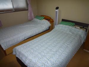 Postel nebo postele na pokoji v ubytování Futami Terrace C