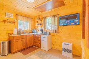 a kitchen with a white refrigerator and a stove at The Skarland Trail Cabin in Fairbanks
