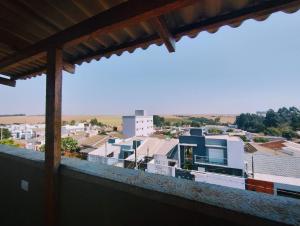a view of a city from the balcony of a building at HAPPY HOSPEDAGENS in Cascavel