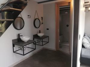 Baño con 2 lavabos y espejos en la pared en Finca 2 - Dakeva, en Guatapé