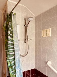 a shower in a bathroom with a shower curtain at 'Melrose' at stayBOOM in Lancaster