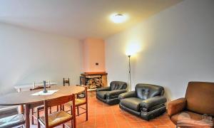 a living room with two chairs and a table and a table and chairsktop at il sentiero del riccio in Sicignano degli Alburni +24 photos
