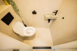 a bathroom with a toilet and a sink at Blissfully 1 Bedroom Serviced Apartment 53m2 -NB306B- in Rotterdam