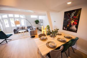 a living room with a table and a couch at Happily 2 Bedroom Serviced Apartment 75m2 -NB306H- in Rotterdam
