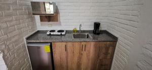 a kitchen with a sink and a counter top at Acogedora suite en Liguiqui - Manta 