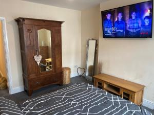 a bedroom with a tv hanging on the wall at Oak Dene in Doncaster