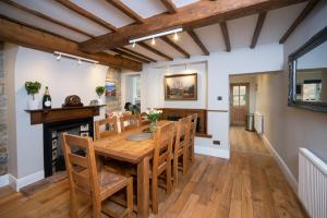 a dining room with a wooden table and chairs at Cotswolds period townhouse near Stratford-upon-Avon, central location short walk to pubs, restaurants and shops in Shipston-on-Stour