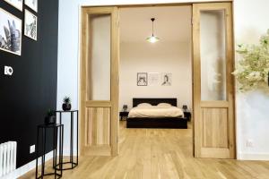 Habitación con una puerta que conduce a un dormitorio en Loft aux portes de Paris - Parking gratuit en Bagnolet