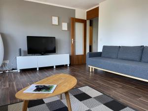 sala de estar con sofá y TV en Ferienwohnung Bergblick en Füssen