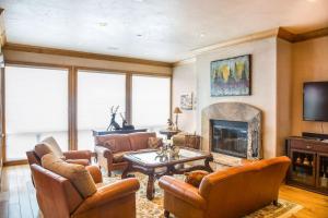 a living room with leather furniture and a fireplace at Snowmass_Owl_Creek_9904 in Snowmass Village