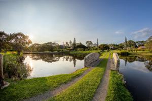 a stone bridge over a river with the sun setting at Petra Santa Hotel Boutique in Pereira +51 photos