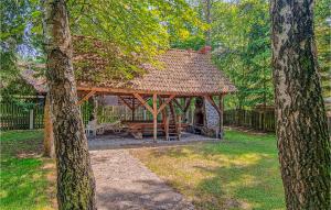 a wooden gazebo in a yard with trees at Nice Home In Ruciane Nida With Wifi in Ruciane-Nida