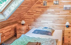 a bedroom in a tiny house with a bed at Nice Home In Ruciane Nida With Wifi in Ruciane-Nida +7 photos