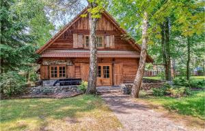 a log cabin in the middle of a forest at Nice Home In Ruciane Nida With Wifi in Ruciane-Nida