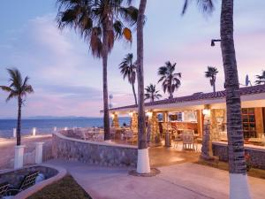 a villa with palm trees and a resort at Punta Pescadero Paradise Hotel & Villas in Los Barriles