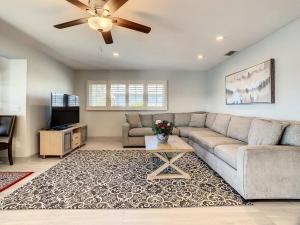 a living room with a couch and a ceiling fan at Amazing water front view home newly renovated 3BD 2BTH in Clearwater Beach