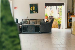 a living room with a table and chairs at Hotel Cañada Internacional in Palenque