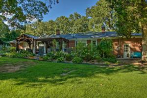 a brick house with a garden in the yard at Charming Florence Getaway with Fireplace and Grill! in Florence