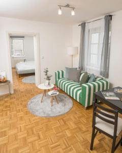 a living room with a couch and a table at Zum Grazer Uhrturm in Graz